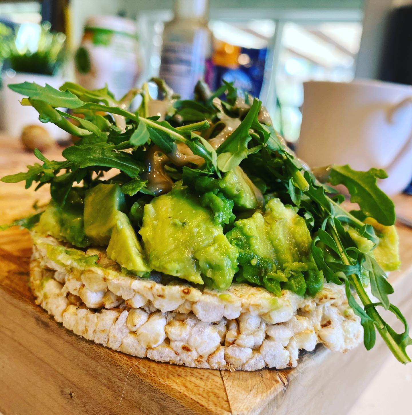 rice cake with avocado greens and tahini